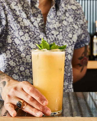 Friend Place cocktail being served by bartender on bar