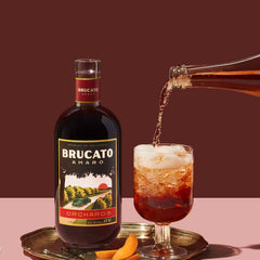 Brucato Amaro Orchards next to bottle pouring a red spritz