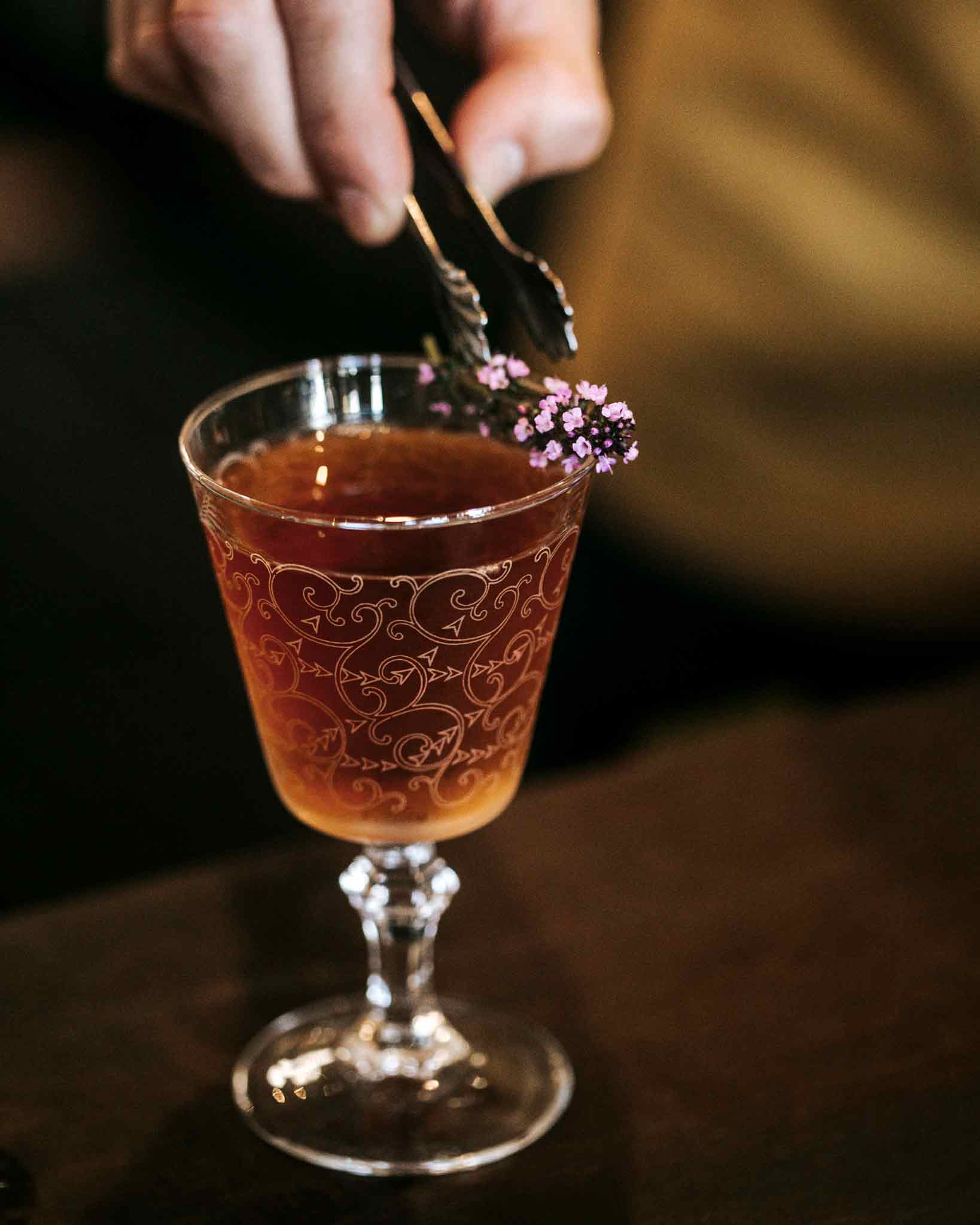 Pinnacles Park cocktail in small glass with thyme sprig