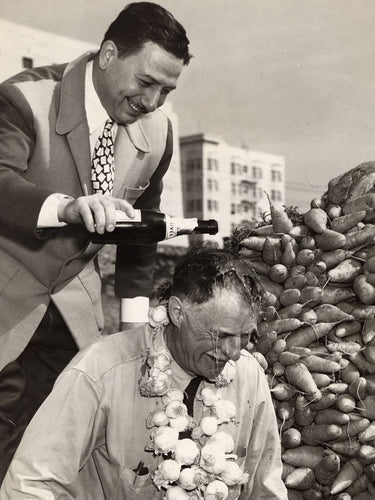 John Brucato pouring champagne on friend's head