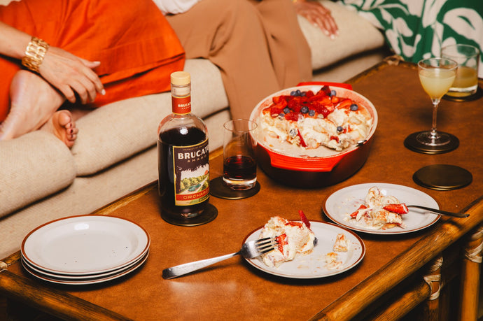 Brucato Amaro Orchards on a table with cocktails, desert