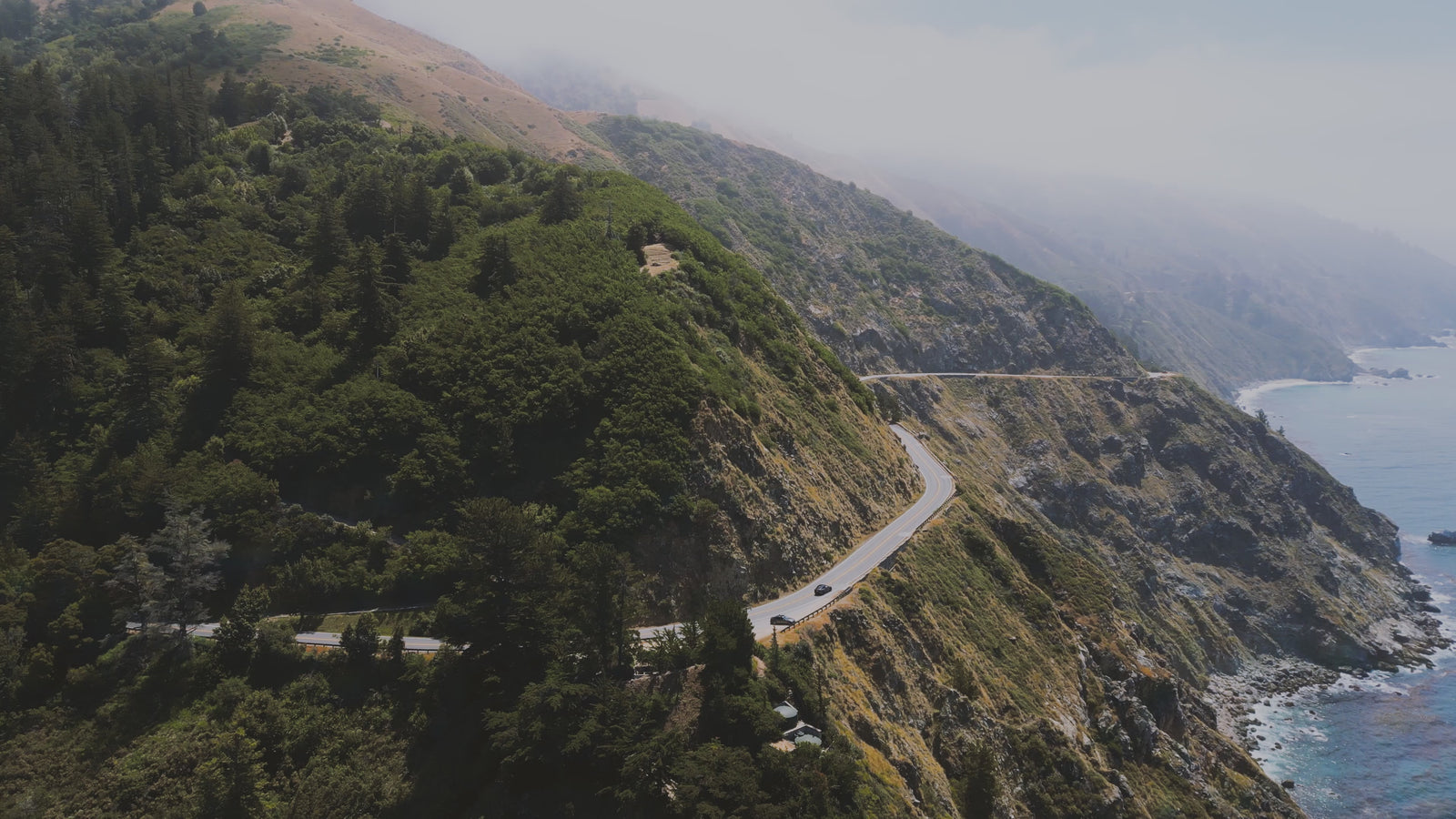 Aerial video of Big Sur, Northern California coast, redwood trees, orchards.